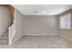 Neutral living room featuring tile floors and staircase leading to the next level at 8486 Insignia Ave # 101, Las Vegas, NV 89178