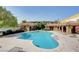 Large community pool with sun loungers and shade, perfect for recreation and relaxation on sunny days at 8486 Insignia Ave # 101, Las Vegas, NV 89178