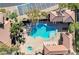 An aerial shot of a pool with surrounding lounge area, seating, and well-manicured landscaping at 8534 Insignia Ave # 101, Las Vegas, NV 89178