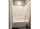 Bathroom with a white tub, white tile surround, chrome fixtures, and neutral walls at 8534 Insignia Ave # 101, Las Vegas, NV 89178