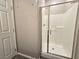 Bright bathroom featuring a glass-enclosed shower with modern fixtures at 8534 Insignia Ave # 101, Las Vegas, NV 89178