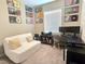 Charming bedroom featuring a comfortable white couch, desk, and unique music decor at 8534 Insignia Ave # 101, Las Vegas, NV 89178