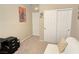 Neutral bedroom with a comfortable couch, closet, and artwork at 8534 Insignia Ave # 101, Las Vegas, NV 89178