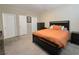 Neutral bedroom featuring a comfortable bed, dresser, and three closets at 8534 Insignia Ave # 101, Las Vegas, NV 89178