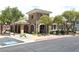 The clubhouse with stone accents, arched entryways, and well-manicured landscaping at 8534 Insignia Ave # 101, Las Vegas, NV 89178