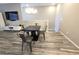 Dining area features a modern table, chairs, wood-look flooring, and a contemporary chandelier, ideal for Gathering gatherings at 8534 Insignia Ave # 101, Las Vegas, NV 89178