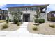 Charming home with a well-maintained lawn and inviting entrance with rocks and desert landscaping at 8534 Insignia Ave # 101, Las Vegas, NV 89178
