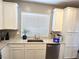 Bright kitchen showcasing stainless steel appliances, granite countertops, modern sink, and white cabinetry at 8534 Insignia Ave # 101, Las Vegas, NV 89178