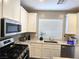 Bright kitchen showcasing stainless steel appliances, granite countertops, modern sink, and white cabinetry at 8534 Insignia Ave # 101, Las Vegas, NV 89178