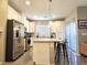 Bright kitchen features white cabinets, stainless steel appliances, granite countertops, and an island with bar stool seating at 8534 Insignia Ave # 101, Las Vegas, NV 89178