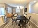 Open-concept living space showcasing a dining table, leather sofa, and contemporary decor, perfect for entertaining at 8534 Insignia Ave # 101, Las Vegas, NV 89178