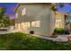Lush backyard with a grassy area, patio, and mature trees, offering a serene outdoor space at 8612 Danza Del Sol Dr, Las Vegas, NV 89128