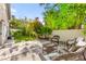 Backyard with a seating area, lawn, and lush tropical landscaping at 8612 Danza Del Sol Dr, Las Vegas, NV 89128
