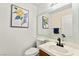 Bathroom with a vanity, toilet, and a decorative mirror at 8612 Danza Del Sol Dr, Las Vegas, NV 89128