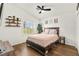 Inviting bedroom with wood floors, plantation shutters, and a ceiling fan at 8612 Danza Del Sol Dr, Las Vegas, NV 89128