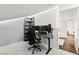 Bright bedroom with a desk, two monitors, and a doorway leading to another room at 8612 Danza Del Sol Dr, Las Vegas, NV 89128