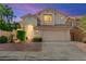 Inviting two-story home with a tile roof, attached garage, and well-maintained landscaping at 8612 Danza Del Sol Dr, Las Vegas, NV 89128