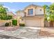 Beautiful two-story home with a spacious driveway and desert landscaping at 8612 Danza Del Sol Dr, Las Vegas, NV 89128