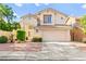 Charming two-story home with well-manicured landscaping and a spacious driveway, offering curb appeal at 8612 Danza Del Sol Dr, Las Vegas, NV 89128