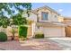 Charming two-story home featuring stucco siding, a tile roof, and well-maintained landscaping at 8612 Danza Del Sol Dr, Las Vegas, NV 89128