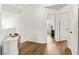 Hallway featuring wood floors and doorways to office and other rooms at 8612 Danza Del Sol Dr, Las Vegas, NV 89128