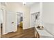 Upstairs hallway with wood floors, white doors, and a bathroom featuring a yellow vanity at 8612 Danza Del Sol Dr, Las Vegas, NV 89128