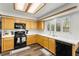 Kitchen with stainless steel appliances, white countertops and wood cabinets at 8612 Danza Del Sol Dr, Las Vegas, NV 89128