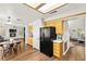 Open eat-in kitchen with black appliances, wooden cabinets, and hardwood flooring at 8612 Danza Del Sol Dr, Las Vegas, NV 89128