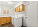 Bright laundry room with cabinets, countertops, and new appliances near exit at 8612 Danza Del Sol Dr, Las Vegas, NV 89128