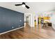 Open-concept living room with blue accent wall leading into kitchen at 8612 Danza Del Sol Dr, Las Vegas, NV 89128