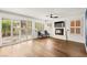 Bright living room with a cozy fireplace, hardwood floors, and sliding door at 8612 Danza Del Sol Dr, Las Vegas, NV 89128
