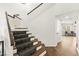 Carpeted staircase with a wood banister and trim at 8612 Danza Del Sol Dr, Las Vegas, NV 89128