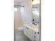 Bright bathroom featuring white tiling, floating vanity with white countertop, and black hardware at 8740 Captains Pl, Las Vegas, NV 89117