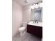 Powder room featuring unique tile flooring, a marble countertop, and modern vanity at 8740 Captains Pl, Las Vegas, NV 89117