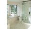Bathroom featuring a glass shower, soaking tub, large windows, and marble countertops at 8740 Captains Pl, Las Vegas, NV 89117