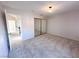 Bedroom featuring neutral carpet and a large mirrored closet with plenty of storage at 8740 Captains Pl, Las Vegas, NV 89117