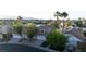 Waterfront house with a well-manicured lawn, mature trees, and a three-car garage at 8740 Captains Pl, Las Vegas, NV 89117