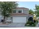 Charming home featuring a two-car garage, tile roof, and mature landscaping at 8740 Captains Pl, Las Vegas, NV 89117