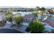 Waterfront home with palm trees, private dock, and mountain views in a lakeside community at 8740 Captains Pl, Las Vegas, NV 89117