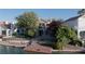 Waterfront home features lush landscaping, mature trees, and private dock at 8740 Captains Pl, Las Vegas, NV 89117
