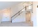 Bright foyer featuring a grand staircase and tiled entryway awaiting renovation at 8740 Captains Pl, Las Vegas, NV 89117