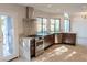 Modern kitchen with stainless steel appliances, custom cabinets, and lake view at 8740 Captains Pl, Las Vegas, NV 89117