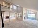 Open concept living room with fireplace, kitchen, and water view at 8740 Captains Pl, Las Vegas, NV 89117