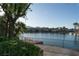 Expansive waterfront view from the backyard showing a dock and mature landscaping at 8740 Captains Pl, Las Vegas, NV 89117