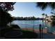 Beautiful waterfront view featuring a private dock and lush landscaping at 8740 Captains Pl, Las Vegas, NV 89117