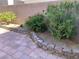 Cozy backyard featuring a brick patio, mature landscaping, and a block wall for added privacy at 8793 Candelabra Ct, Las Vegas, NV 89148
