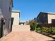 View of the backyard showing the brick paved area between the houses with side planter at 8793 Candelabra Ct, Las Vegas, NV 89148