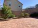 Wide shot of a brick-paved backyard, with decorative plants and block wall at 8793 Candelabra Ct, Las Vegas, NV 89148