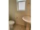 Powder room featuring a sleek pedestal sink, tiled flooring, and modern fixtures at 8793 Candelabra Ct, Las Vegas, NV 89148