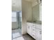 Bright bathroom featuring double sink vanity, quartz countertops and framed glass shower at 8793 Candelabra Ct, Las Vegas, NV 89148
